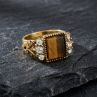 Tigers Eye Gemstone Crystal Accent Ring
on a dark stone surface