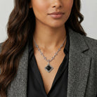 Woman in a blazer wearing a Belladonna Black Glass Stone Filigree Pendant Necklace