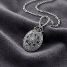 Deco Floral Blue Enamel Sapphire Crystal Mirror Pendant Necklace on dark colored fabric