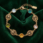 Multicolor Euro Channel Crystal & Filigree Bracelet resting on dark green fabric