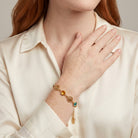 Woman in a cream top wearing Multicolor Euro Channel Crystal & Filigree Bracelet