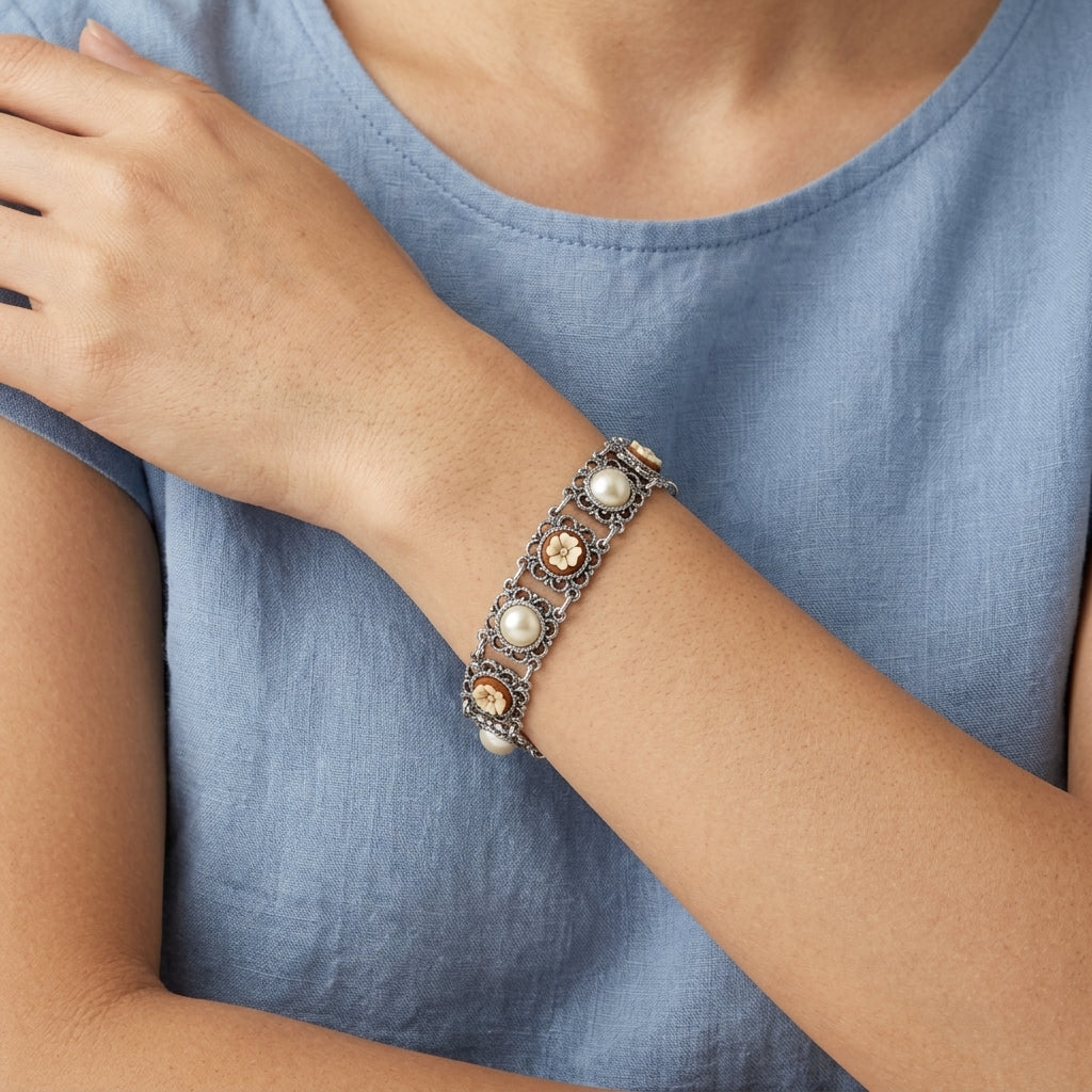 Close-up of a person wearing a decorative Floral Link Faux Pearl & Ivory Flower Stone Bracelet