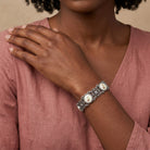 Woman in a pink hote wearing a Meso Round Intricate Filigree Pink & White Stone Link Bracelet 