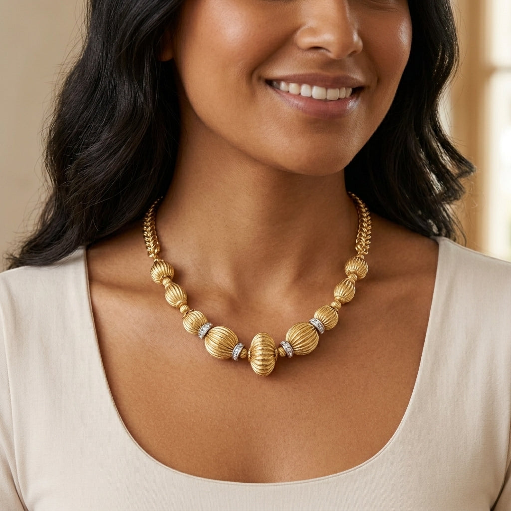 Woman wearing a Corrugated Bead Crystal Accent Twisted Link Necklace with a white top