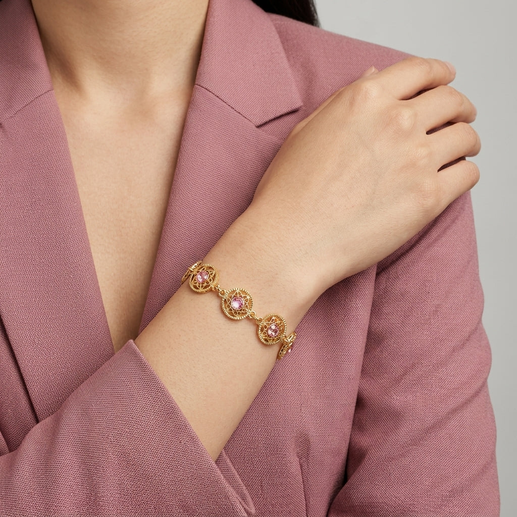 Woman in a pink blazer wearing a Star Disk Channel Crystal Link Bracelet