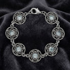 Silver Star Disk Light Sapphire Channel Crystal Link Bracelet on a dark fabric background
