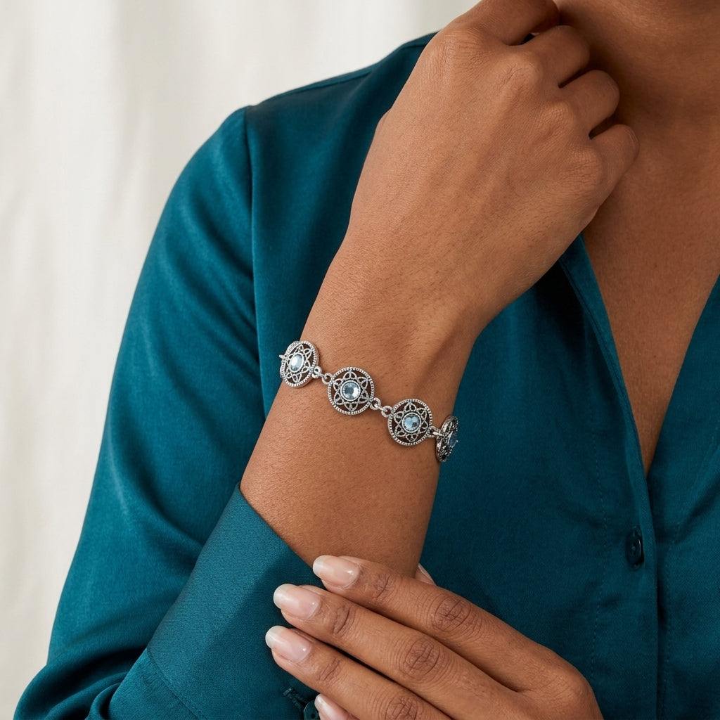 Person wearing a silver Star Disk Light Sapphire Channel Crystal Link Bracelet