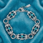 Deco Flare Aqua Blue Crystal Link Bracelet resting on light blue fabric