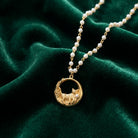 Cat & Flowers Faux Pearl Pendant Necklace on dark green fabric