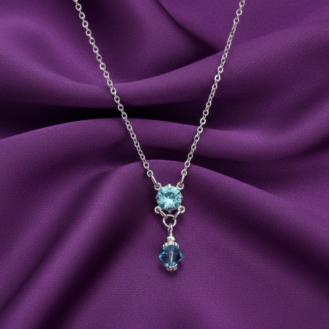 Necklace with blue gemstones on a purple fabric background