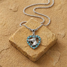 Heart Horse Head Turquoise Crystal Pendant Necklace on a stone surface.