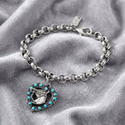Heart With Horse Turquoise Crystal Round Link Bracelet resting on gray fabric 