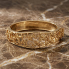 Gold Floral Hinge Bracelet resting on marble surface