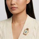 Woman wearing a decorative Dog & Multicolor Floral Decal Pin brooch on a plain background