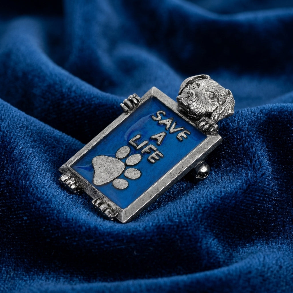 Metallic pin with 'Save a Life' dog and paw print on blue fabric