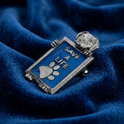 Metallic pin with 'Save a Life' dog and paw print on blue fabric