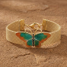 Metamorphic Butterfly Weave Chain Bracelet resting on sandstone surface