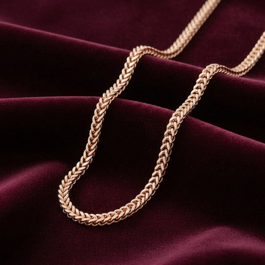 Gold Tone Double Curb Chain Necklace resting on maroon fabric