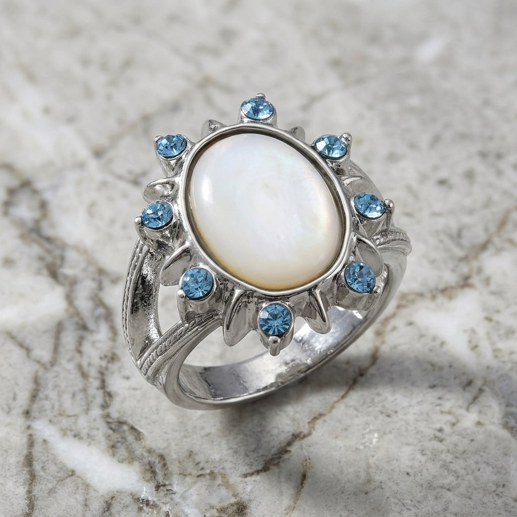Aquamarine Crystal Crystal Mother Of Pearl Ring resting on marble surface