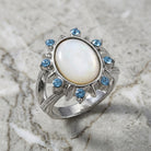 Aquamarine Crystal Crystal Mother Of Pearl Ring resting on marble surface
