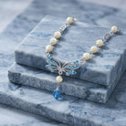 Aquamarine Crystal Mother Of Pearl Drop Necklace resting on blocks of blue marble stone
