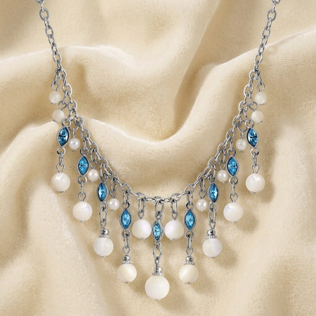 Aquamarine Crystal Mother Of Pearl Bib Necklace resting on white fabric