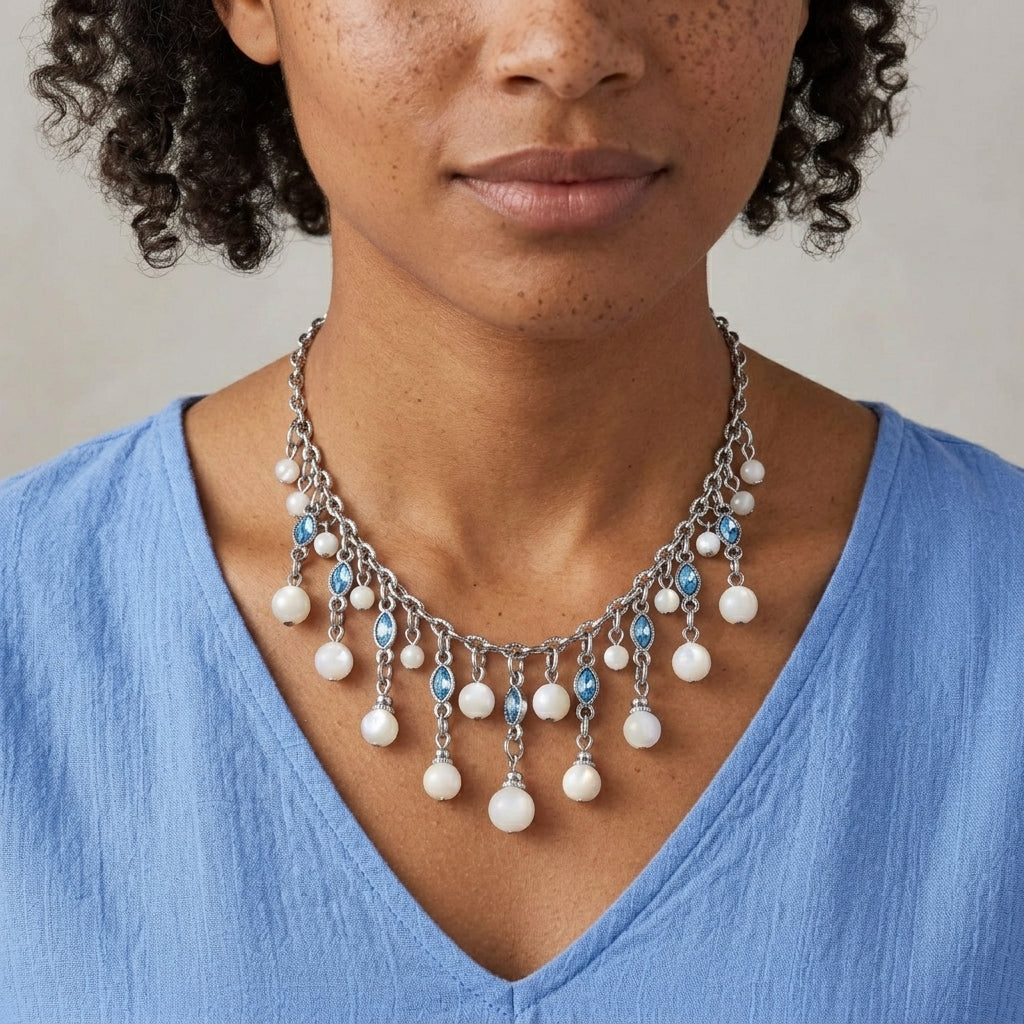 Woman in a blue top wearing our Aquamarine Crystal Mother Of Pearl Bib Necklace 