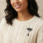 Woman wearing a beige cable knit sweater with Deco Fantasy Crystal & Black Stone Statement Brooch Pin