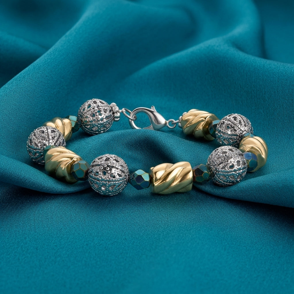 Twisted Bead Filigree Puff Ball Fire Polished Green Bead Link Bracelet resting on teal fabric surface