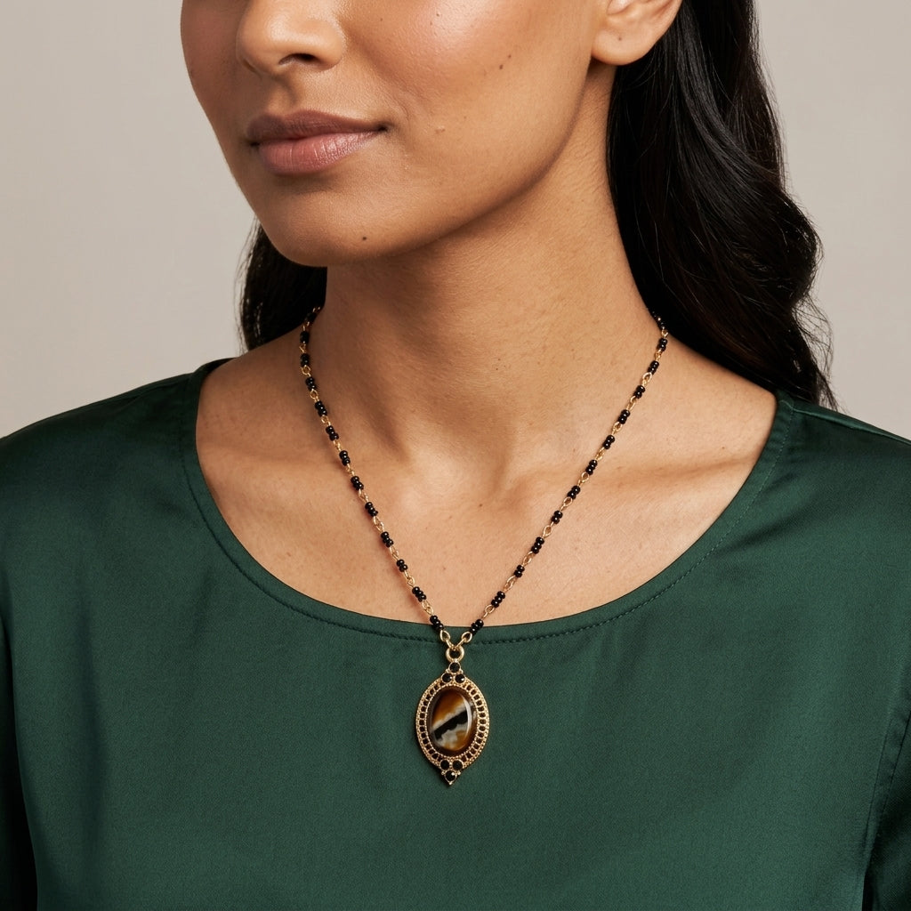 Woman in a green top wearing Tigers Eye Glass Stone Pendant Necklace