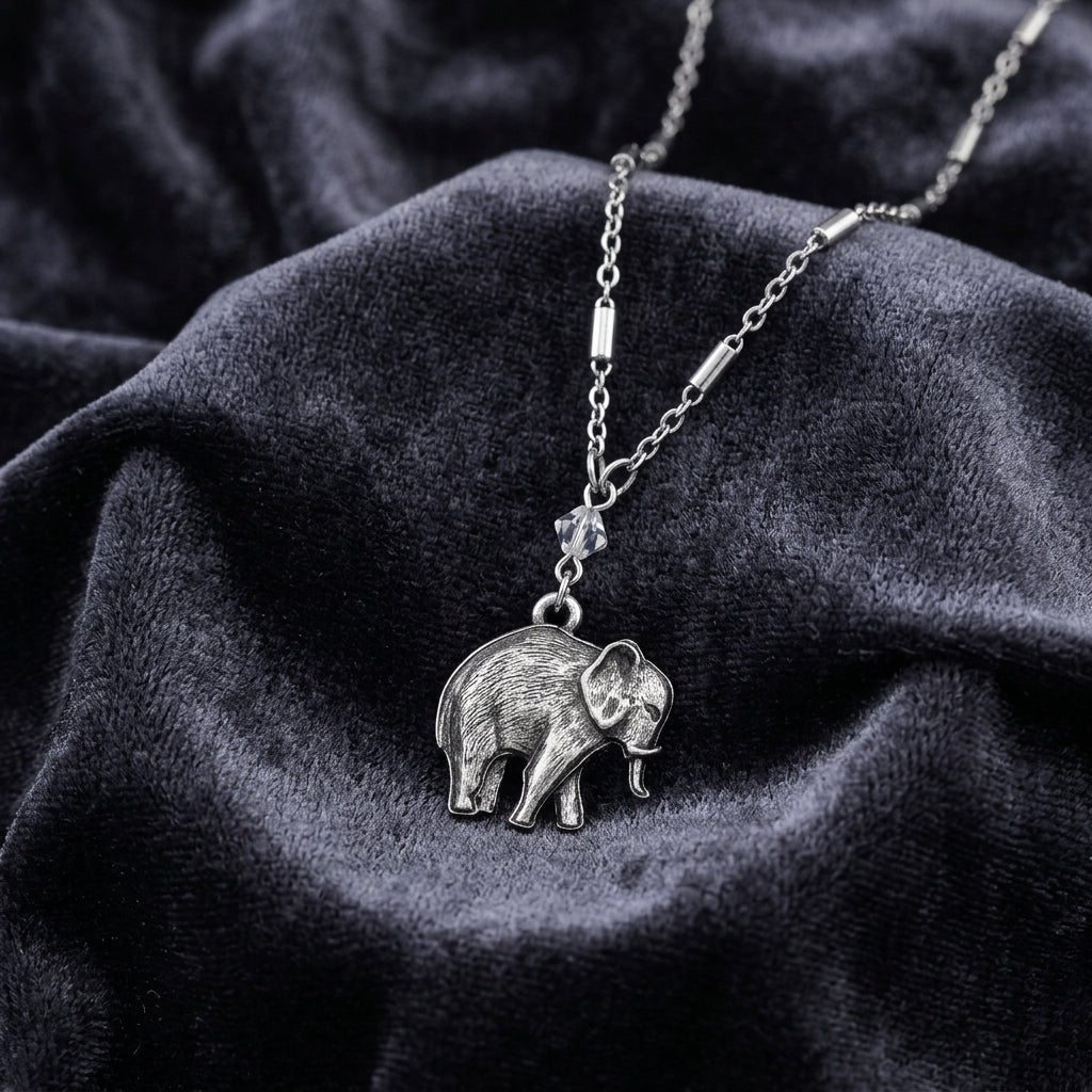 Pewter Elephant Drop Chain Pendant Necklace resting on dark fabric 
