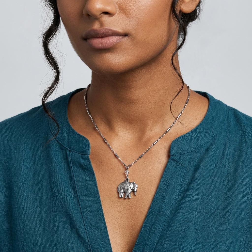 Woman in a teal dress wearing our Pewter Elephant Drop Chain Pendant Necklace