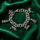 Pewter 6 Cat Charm Bracelet resting on dark green fabric