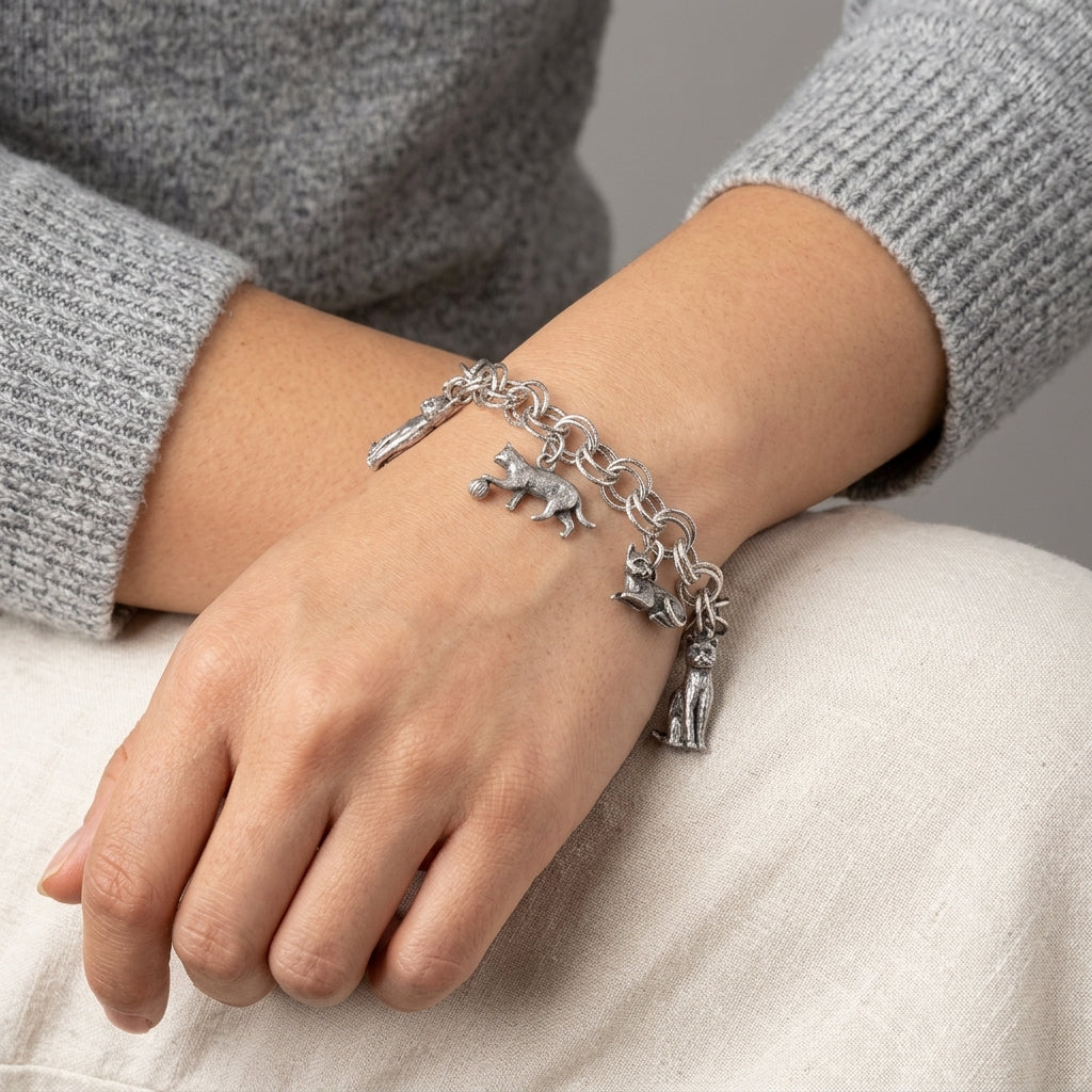 Woman wearing a Pewter 6 Cat Charm Bracelet on her wrist