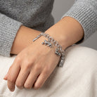 Woman wearing a Pewter 6 Cat Charm Bracelet on her wrist