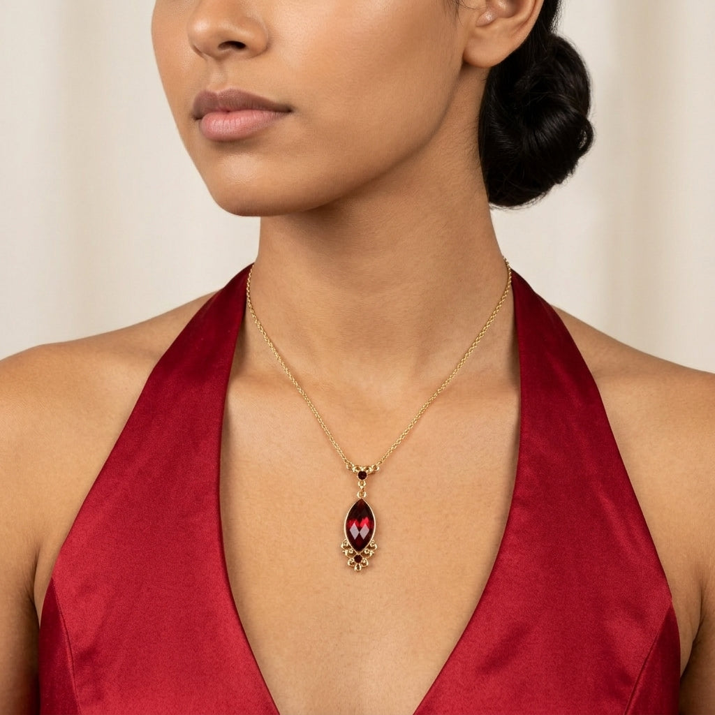 Woman in an elegant red dress wearing our Alluring Siam Red Filigree Pendant Necklace