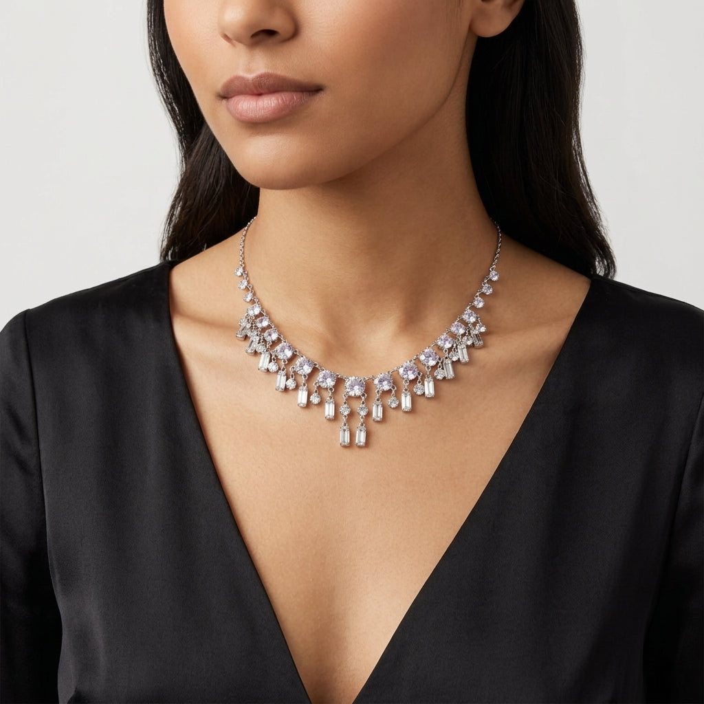 Woman wearing a sparkling Austrian crystal necklace with round and baguette stones against a neutral background