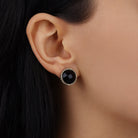 Woman wearing these Black Round Faceted Stone Button Clip On Earrings in a close up model shot