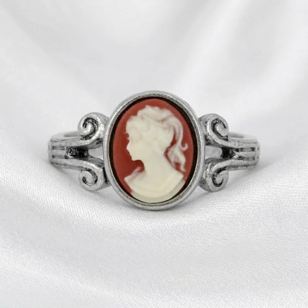 Silver ring with a carnelian red cameo featuring a profile of a woman on a white background