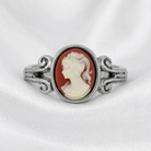 Silver ring with a carnelian red cameo featuring a profile of a woman on a white background