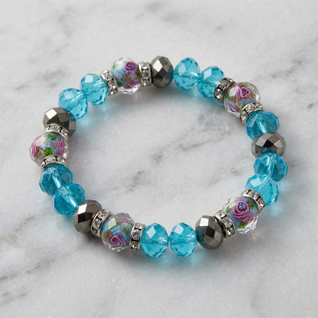 Pink Flower and Blue Bead Crystal Stretch Bracelet resting on marble surface