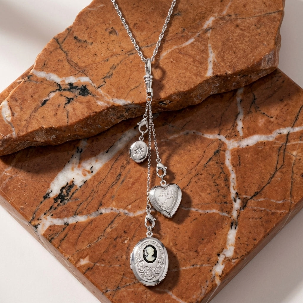 Closed Multi Charm Heart & Oval Black Cameo Locket Necklace resting on brown marble stone surface