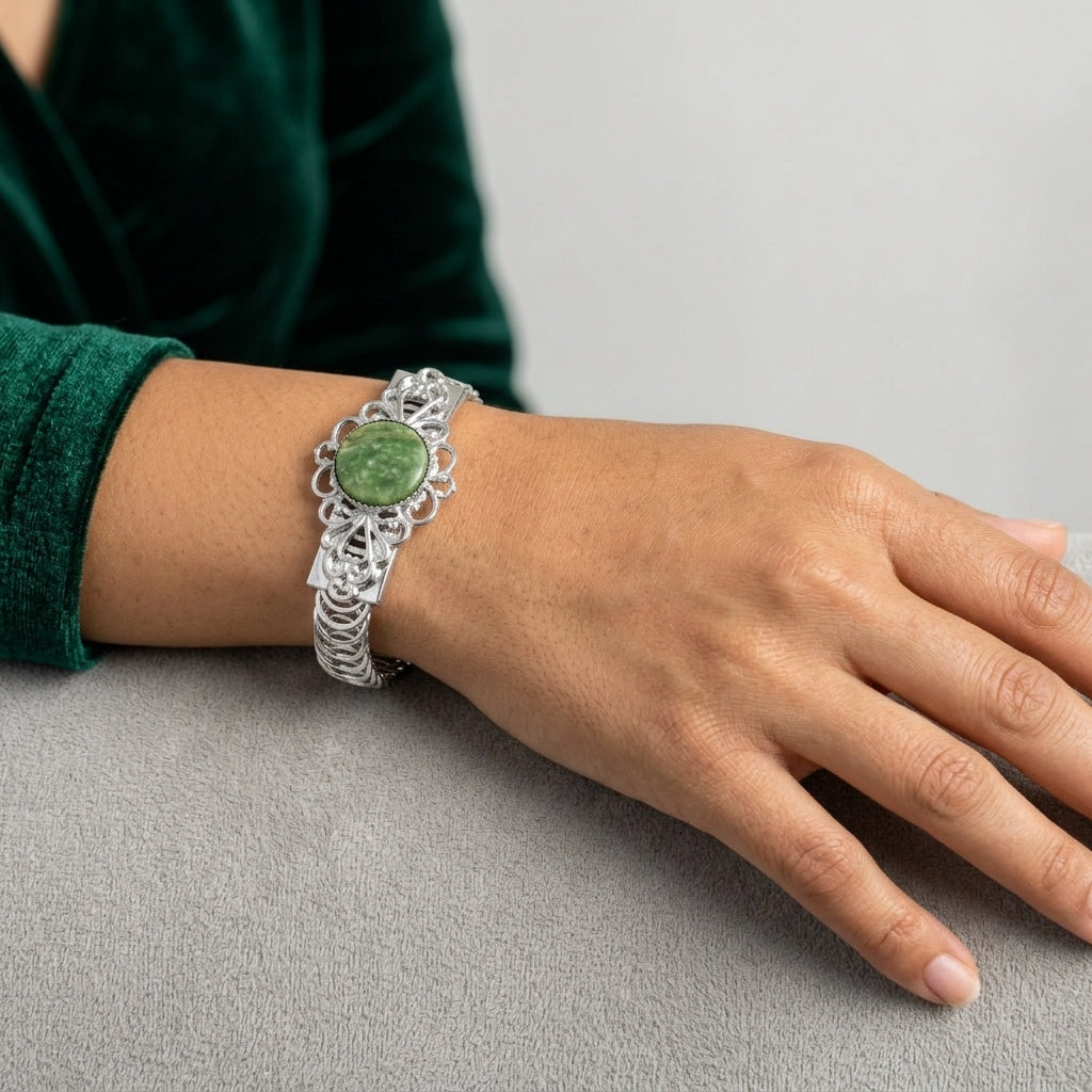 Silver tone Jade Gemstone Belt Bracelet worn on a woman's wrist wearing a green dress