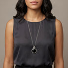 Woman in a dark sleeveless top wearing an Onyx Cabochon Round Gemstone Pendant Necklace
