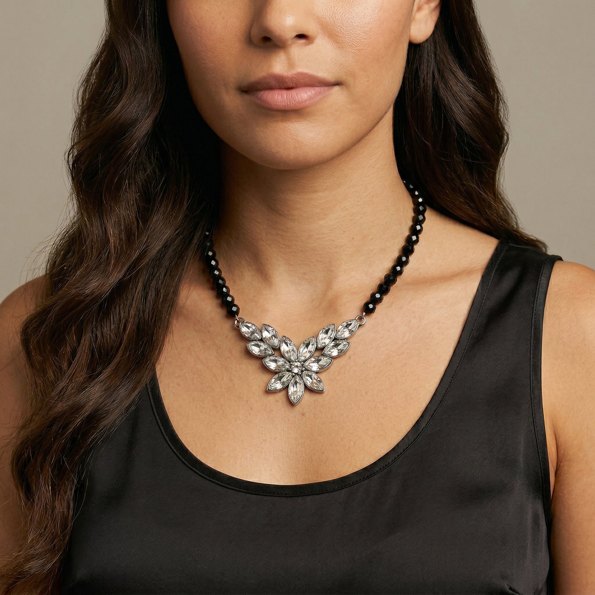 Woman in a black top wearing our Austrian Crystal Flower & Black Glass Beaded Necklace