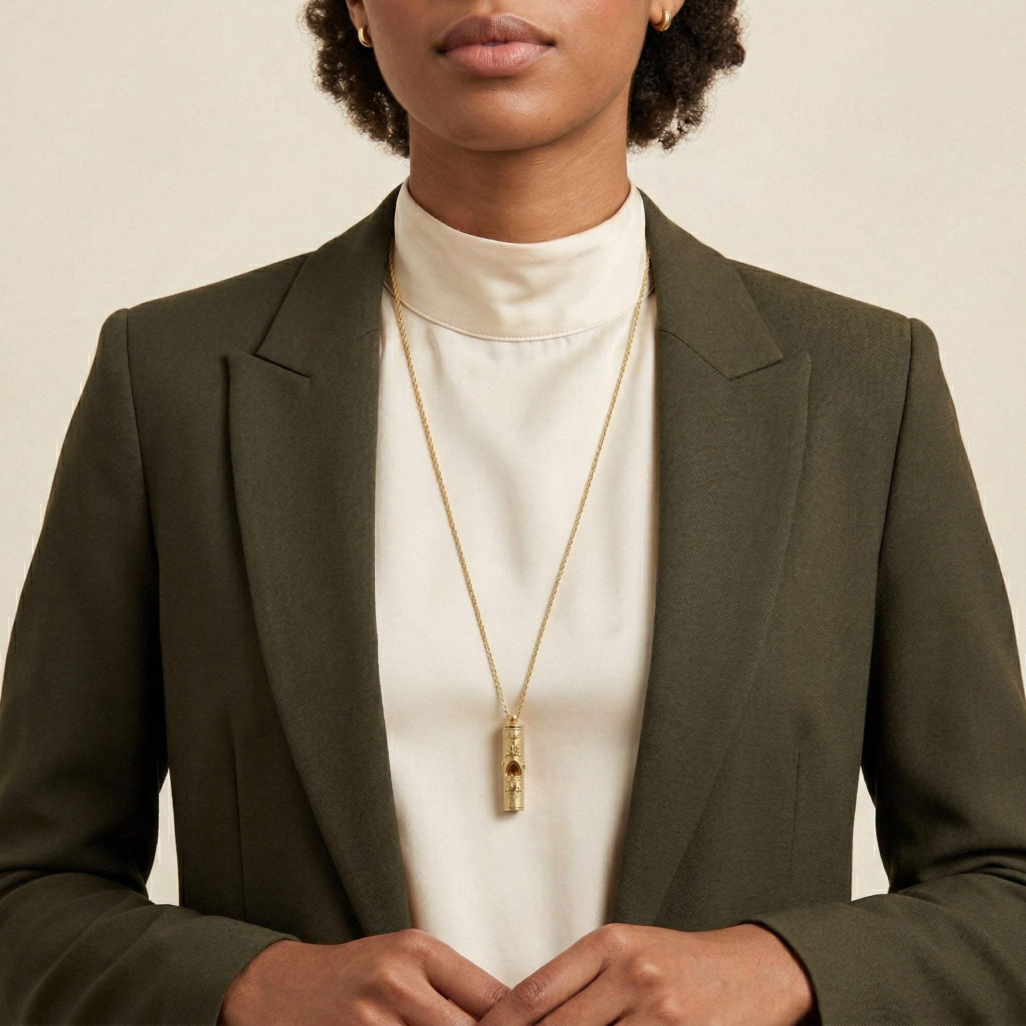 Woman in a dark and turtleneck wearing a gold tone Cat Pendant Necklace Whistle 