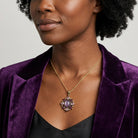 Woman in a purple blazer wearing a matching purple Multi Crystal And Oval Stone Pendant Necklace