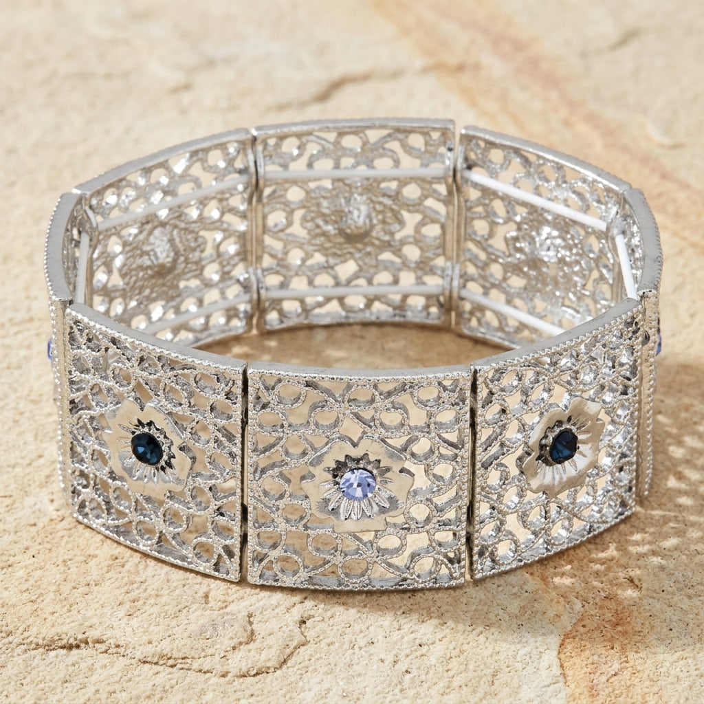 Sapphire Blue Crystal Filigree Stretch Bracelet resting on a light stone surface