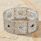 Sapphire Blue Crystal Filigree Stretch Bracelet resting on a light stone surface