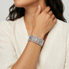 Woman in a white top wearing our Sapphire Blue Crystal Filigree Stretch Bracelet